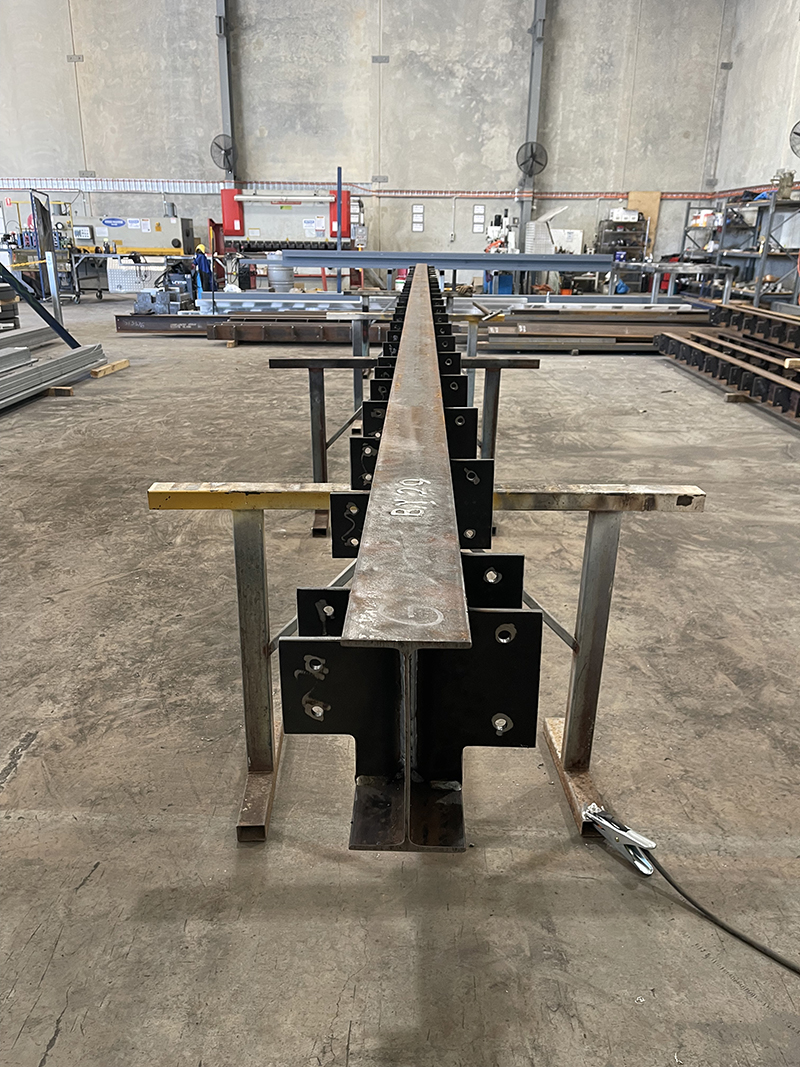 Fabricated beam for subfloor, completing weld out.