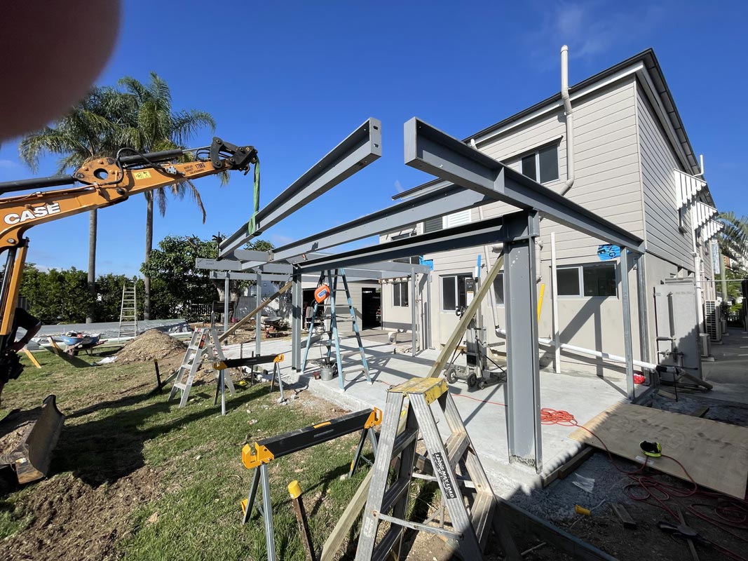 Installing structural steel on a residential property and welding connections.